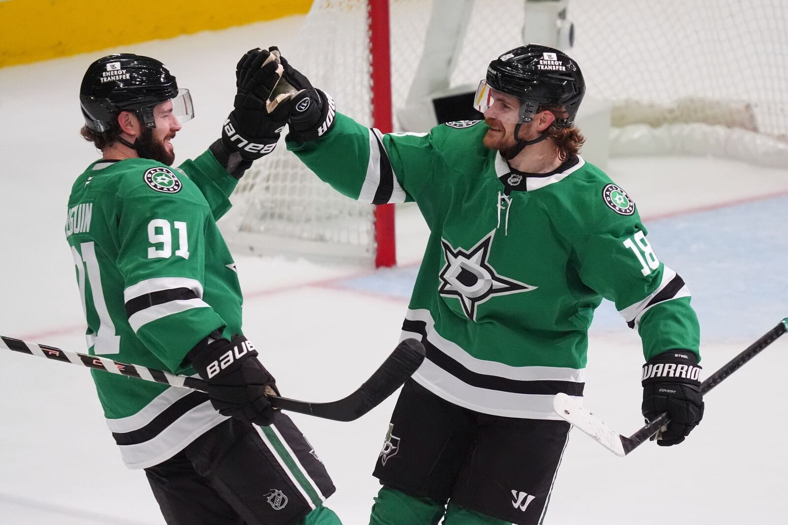 Dallas Stars center Tyler Seguin (91) celebrates his goal with teammate center Sam Steel (18) during the third period in Game 1 of the Western Conference finals in the NHL hockey Stanley Cup playoffs against the Edmonton Oilers, Wednesday, May 21, 2025, in Dallas. (AP Photo/LM Otero)