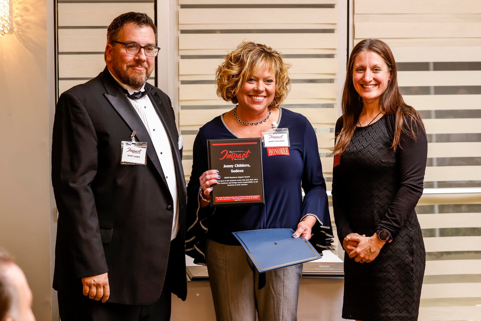 Scott Lewis, left, and Middletown Mayor Nicole Condrey, right, present Jenny Childers with Sodexo with the 2020 Business Impact award during the Kingswell Impact Gala and Awards program held Thursday, Dec. 9, 2021 at The Niderdale Event Center at Brown's Run Country Club in Madison Township. The awards program honored people or groups in the community making a positive impact and demonstrating excellence. NICK GRAHAM / STAFF