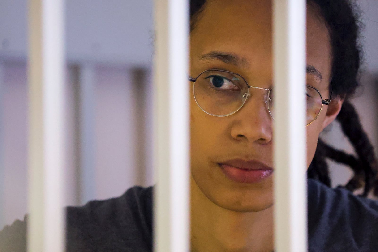 FILE - Basketball player Brittney Griner listens to her verdict while standing in a cage in a courtroom in Khimki, outside Moscow, Russia, Aug. 4, 2022. (Evgenia Novozhenina/Pool Photo via AP, File)