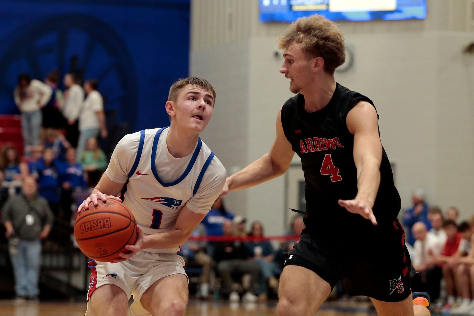 Tri-Village senior Trey Sagester begins to pull up for a jump next to Preble Shawnee junior Caleb Blankenship. Tri-Village defeated Preble Shawnee 55-20 in a WOAC boys basketball game on Friday, Feb. 13, 2026, in New Madison. STEVEN WRIGHT / STAFF