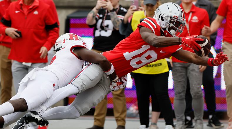 Rutgers defensive back Avery Young, left, tackles Ohio State receiver Marvin Harrison during the first half of an NCAA college football game, Saturday, Oct. 1, 2022, in Columbus, Ohio. (AP Photo/Jay LaPrete)