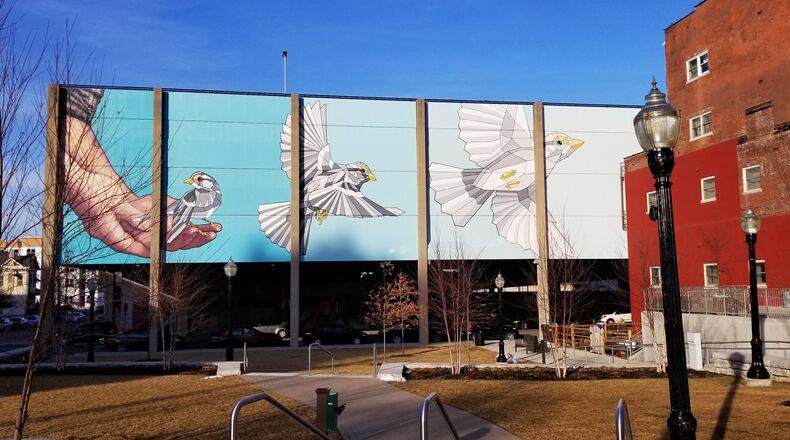 A mural titled " Taking Flight" covers the side of the the McDulin Garage mural in downtown Hamilton. The mural is located near the corner of High Street and Second Street at Rotary Park. contributed by Michael Graham