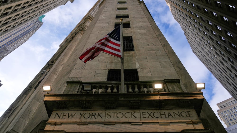 An American flag is displayed over an entrance to the New York Stock Exchange in New York, Thursday, Feb. 12, 2026. (AP Photo/Seth Wenig)