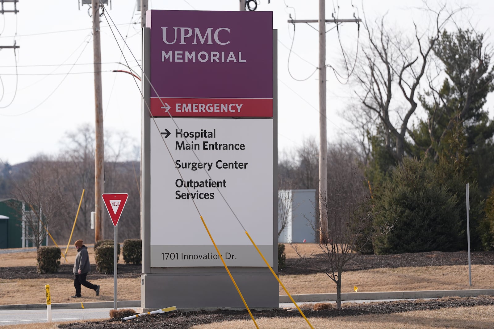 FILE - A person walks by the entrance of UPMC Memorial Hospital in York, Pa., Feb. 22, 2025. (AP Photo/Matt Rourke, File)
