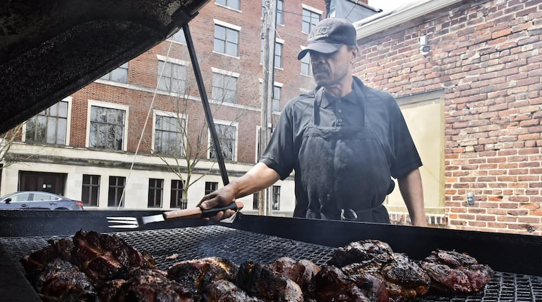 Leonard Ross mans the smoker Wednesday, April 15 at Neal’s Famous BBQ in Hamilton. The Greater Hamilton Chamber of Commerce has set up a website to allow the purchase of gifts certificates that support Hamilton businesses. The site is the next step in a program approved by the Hamilton City Council last month that spent $300,000 buying the gift certificates to help the businesses with immediate cash infusions. Neal’s Famous BBQ is one of the businesses with gift cards available. NICK GRAHAM / STAFF