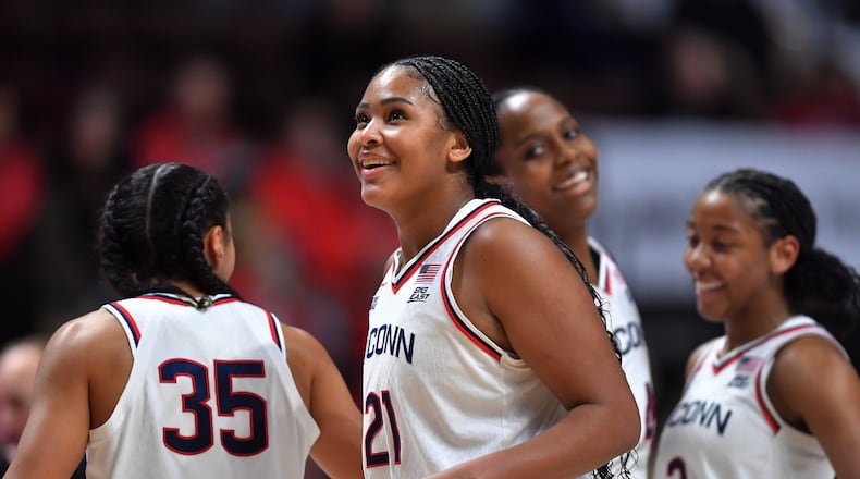 UConn forward Sarah Strong (21) celebrates with guards Azzi Fudd (35) and KK Arnold (2) as they lead Utah in the second half of an NCAA college basketball game, Sunday, Nov. 23, 2025, in Uncasville, Conn. (AP Photo/Steven Senne)