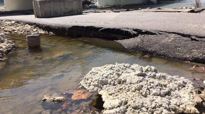 Flooding of the Great Miami River not only damaged the bike path along the river in Hamilton, but it also damaged this pathway in Dayton. SEAN CUDAHY/STAFF