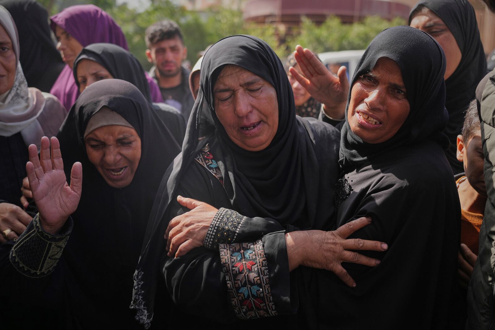Palestinians mourn during the funeral of Reem Al-Akhras, who was killed while heading to an aid distribution hub, in Khan Younis, Gaza Strip, Tuesday, June 3, 2025. (AP Photo/Abdel Kareem Hana)