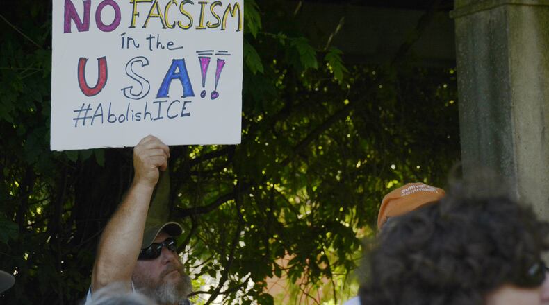 A protester holds a signs on Saturday, June 30, 2018, at Memorial Park in Uptown Oxford during a rally protesting President Donald Trump’s immigration policy where migrant children were separated from their families as they crossed the U.S.-Mexico border over the past several weeks. Trump has since signed an order directing that families not be separated, though thousands are still separated, according to national media reports. MICHAEL D. PITMAN/STAFF
