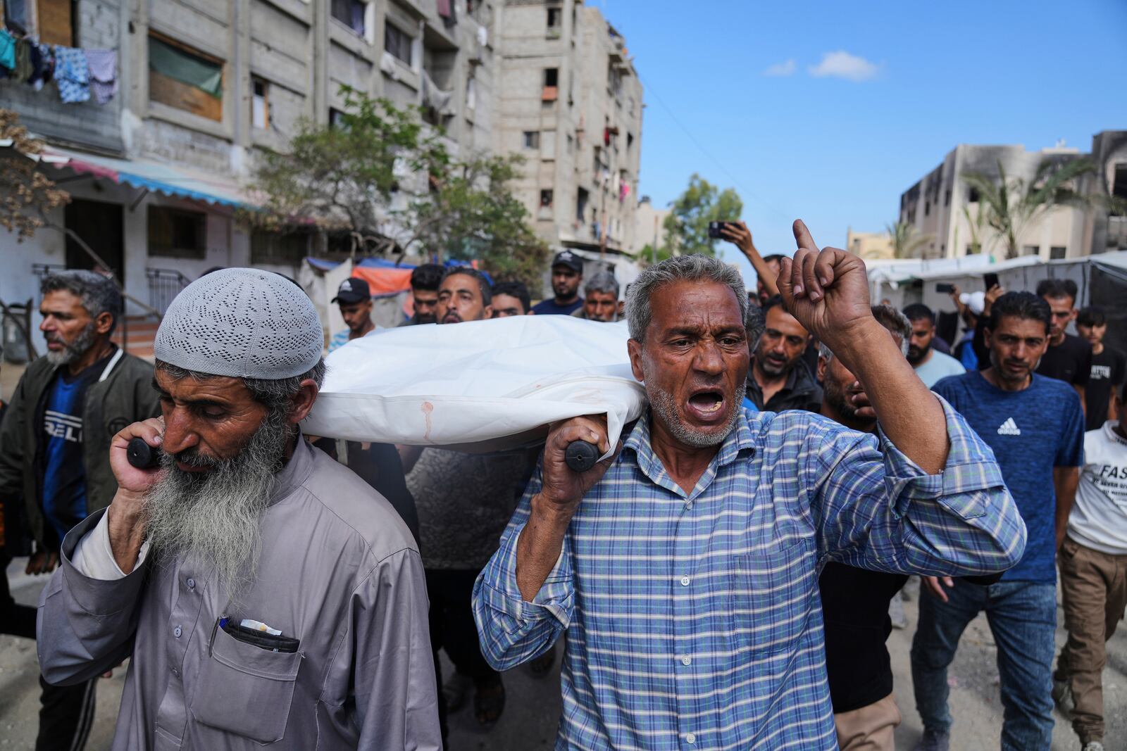 Palestinians carry Reem Al-Akhras, who was killed while heading to an aid distribution hub, during her funeral in Khan Younis, Gaza Strip, Tuesday, June 3, 2025. (AP Photo/Abdel Kareem Hana)