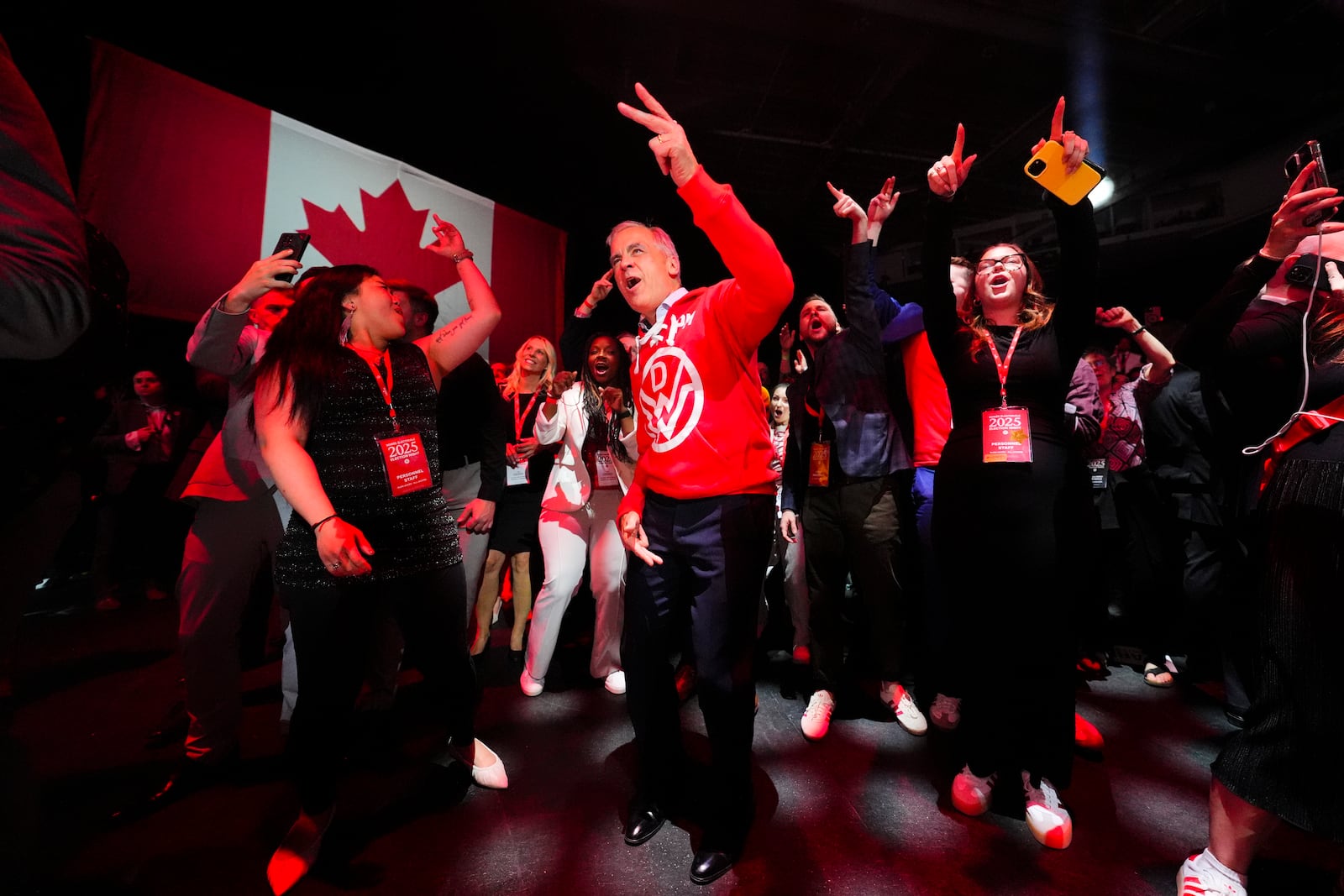 Canadian Prime Minister Mark Carney, center, dances to Canadian band Down With Webster as they play live from campaign headquarters after the Liberal Party won the Canadian election in Ottawa on Tuesday, April 29, 2025. (Sean Kilpatrick/The Canadian Press via AP)