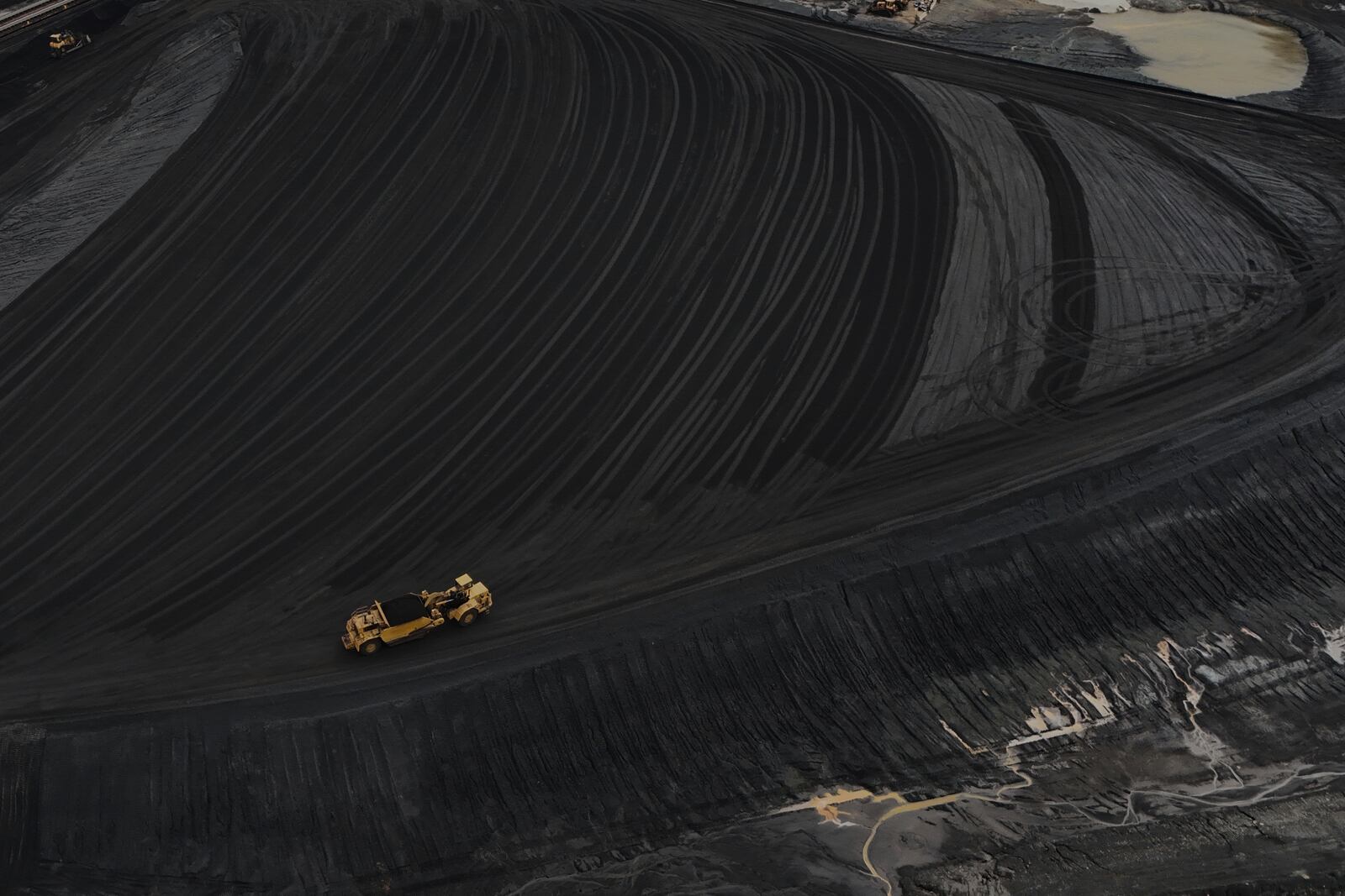 Heavy equipment moves through coal at the Gen. James Gavin Power Plant, a coal-fired power plant, Monday, April 14, 2025, in Cheshire, Ohio. (AP Photo/Joshua A. Bickel)