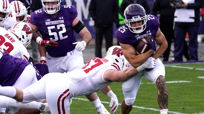 Northwestern running back Isaiah Bowser, right, is tackled by Wisconsin linebacker Jack Sanborn during the first half of an NCAA college football game in Evanston, Ill., Saturday, Nov. 21, 2020. (AP Photo/Nam Y. Huh)