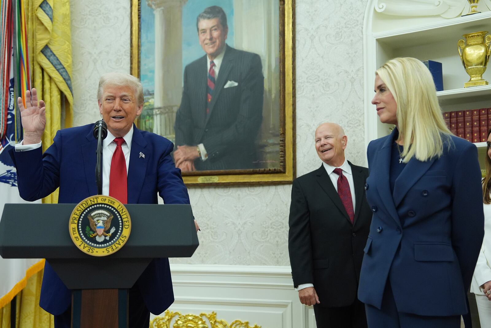President Donald Trump, left, gestures as Attorney Genera, Pam Bondi, right, looks on during a swearing in ceremony for interim U.S. Attorney General for the District of Columbia Jeanine Pirro, Wednesday, May 28, 2025, in the Oval Office of the Whit House in Washington. (AP Photo/Evan Vucci)
