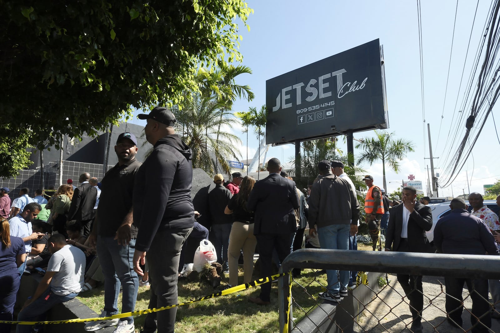 People gather outside the Jet Set nightclub after its roof collapsed during a merengue concert in Santo Domingo, Dominican Republic, Tuesday, April 8, 2025. (AP Photo/Ricardo Hernandez)