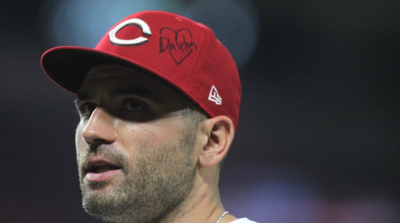 Reds first baseman Joey Votto wears a hat paying tribute to Dayton during a game against the Angels on Tuesday, Aug. 6, 2019, at Great American Ball Park in Cincinnati.