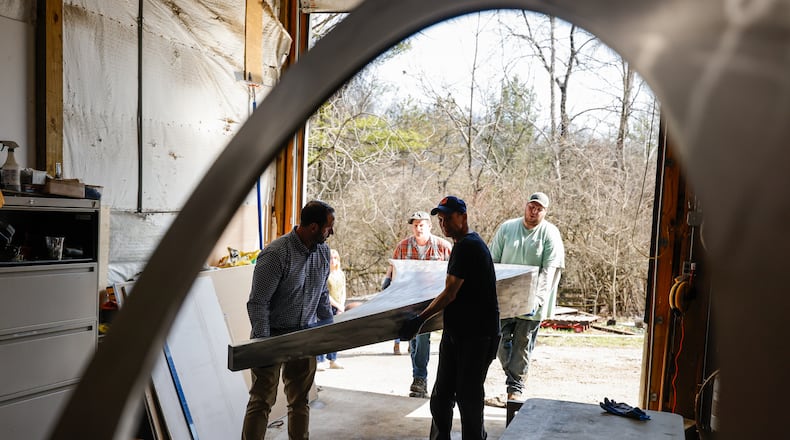 Pyramid Hill Sculpture Park employees work to unload a sculpture by internationally recognized sculptor and public artist Barton Rubenstein Friday, March 6, 2026. The new piece will be on display in April. NICK GRAHAM/STAFF