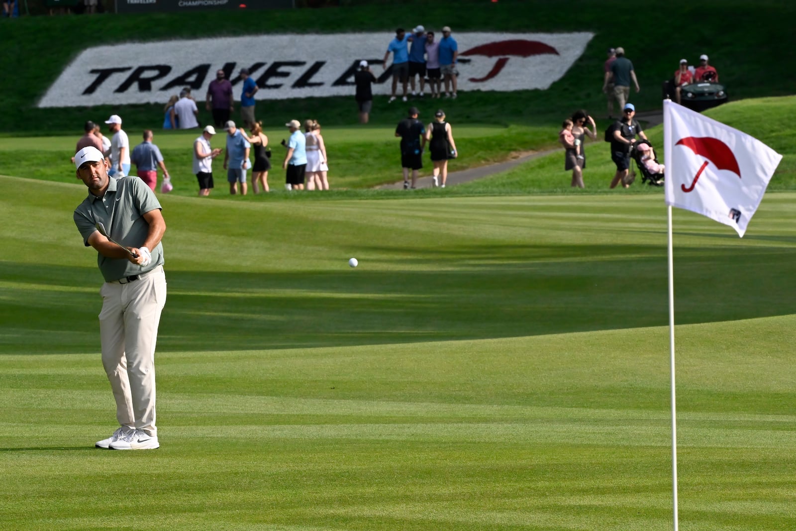 Scottie Scheffler hits his second shot on the 15th hole during the third round of the Travelers Championship golf tournament at TPC River Highlands, Saturday, June 21, 2025, in Cromwell, Conn. (AP Photo/Jessica Hill)
