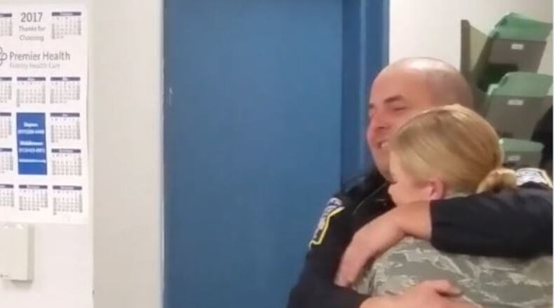 Middlwtown police officer John Palmer hugs his daughter, Airman McKinley Palmer, during a surprise visit on Christmas Eve.