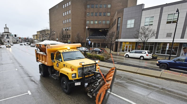 Hamilton residents starting in January will be able to go online to see what streets have been salted or recently cleared by snow plows. Here, a snow plow truck applied salt in 2017 to High Street as freezing rain started to fall. NICK GRAHAM/STAFF