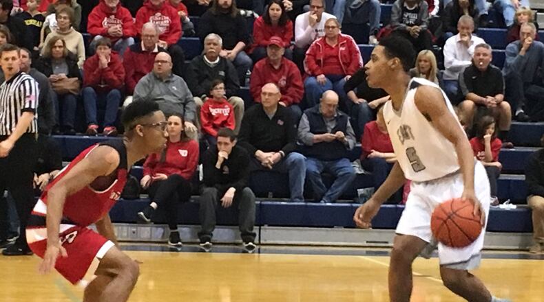 Lakota East’s Nate Johnson (5) dribbles into the defensive area of La Salle’s Quinn Ealy (11) during a Division I sectional final March 2, 2018, at the Hamilton Athletic Center. East won 60-54. RICK CASSANO/STAFF
