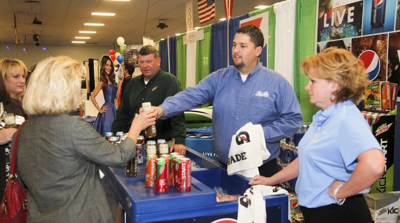 Nick Boggs, Chris Lusk, and Sandy Ratliff of Pepsi, hand out drink samples during a previous West Chester-Liberty Chamber Alliance Regional Business Expo held at Skatetown USA in West Chester Twp. The annual event is preceded by a Taste of West Chester/Liberty luncheon that features Pepsi and more than 40 other dining and beverage vendors. GREG LYNCH / STAFF