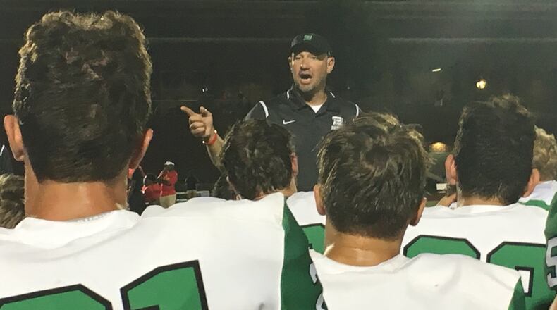 Badin coach Nick Yordy speaks to his team after last Saturday night’s 42-12 triumph over Purcell Marian at Walnut Hills’ Marx Stadium. RICK CASSANO/STAFF