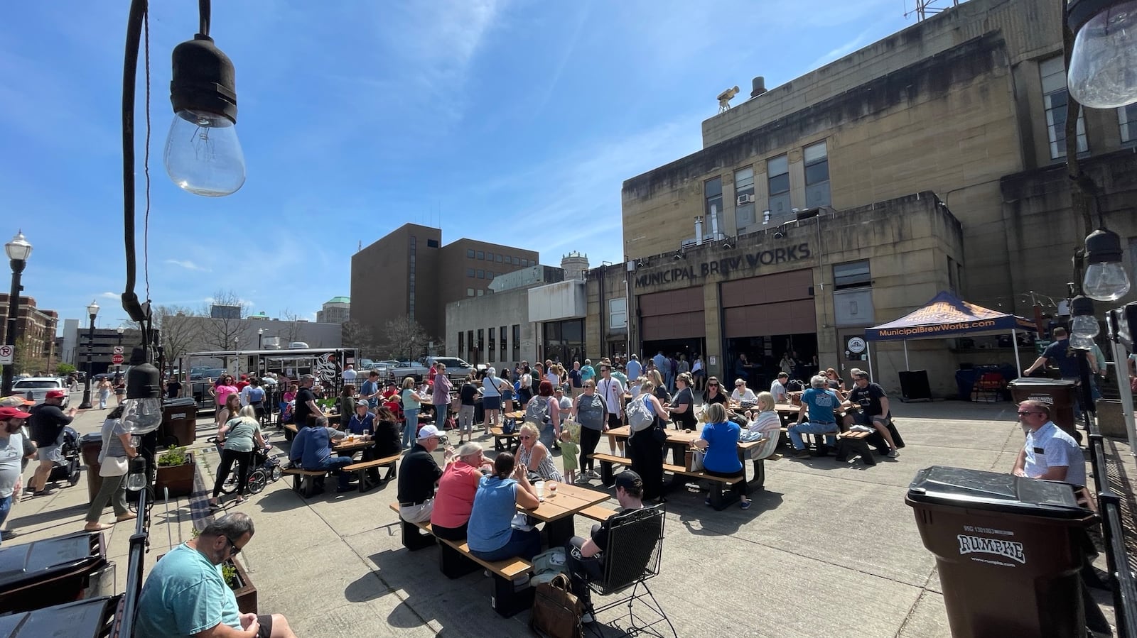 The crowd for the eclipse watchers are filling up downtown establishments and Marcum Park in Hamilton. This is the scene on Monday afternoon, April 8, 2024, at Municipal Brew Works. MICHAEL D. PITMAN/STAFF