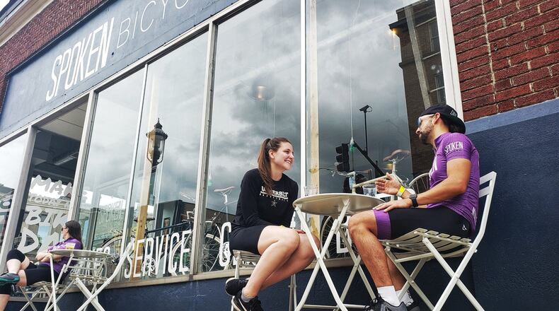 Whitney Wyckoff and Matthew Russell use the outdoor seating at Spoken Bicycles Saturday, May 16. 2020, in Middletown. Outdoor seating for restaurants and bars was reopened Friday after nearly two months of being shut down during the coronavirus pandemic. NICK GRAHAM/STAFF