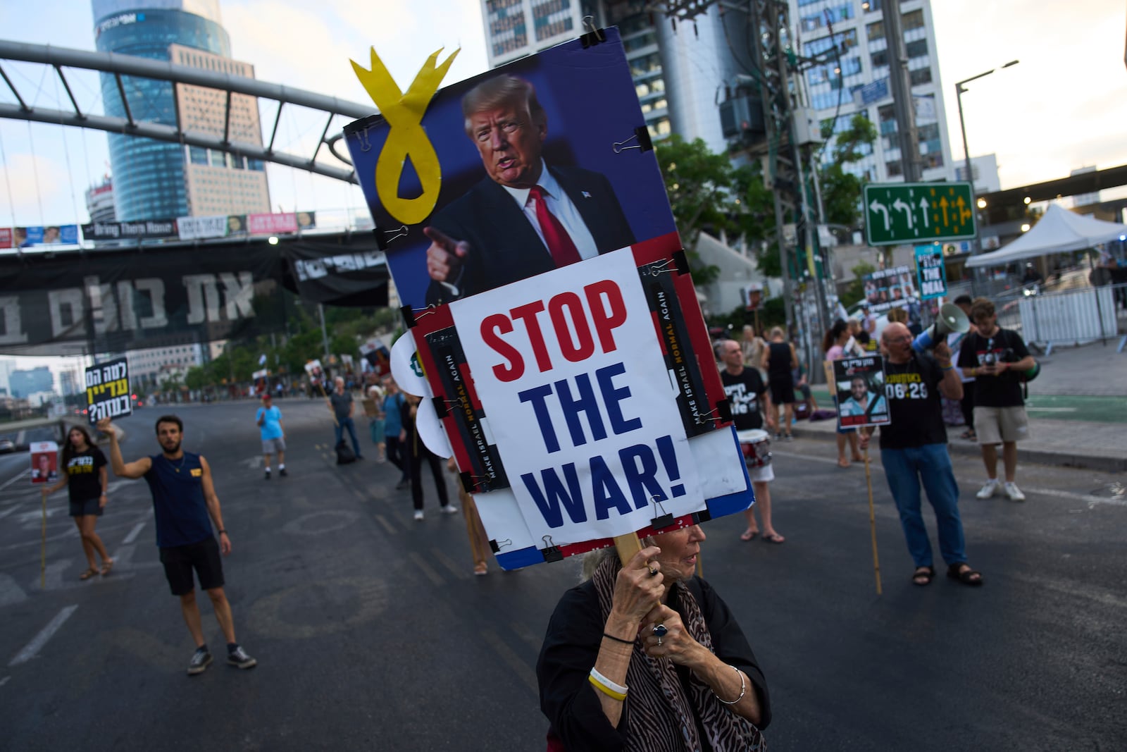 Relatives of hostages held by Hamas in the Gaza Strip and their supporters call for an immediate hostage release deal during a protest in Tel Aviv, Israel, Thursday, July 10, 2025. (AP Photo/Ariel Schalit)