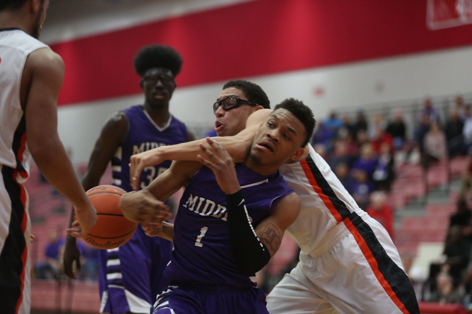 Wilmington guard Jeffery Mansfield chases a rebound over Middletown guard Nelson Rutledge during their Division I sectional game at Fairfield Arena on Tuesday night. CONTRIBUTED PHOTO BY E.L. HUBBARD