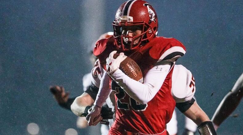 Madison’s Jake Phelps runs for a touchdown last Friday night during a 64-0 victory over Waynesville at Brandenburg Field in Madison Township. The win completed the Mohawks’ first-ever 10-0 regular season. NICK GRAHAM/STAFF