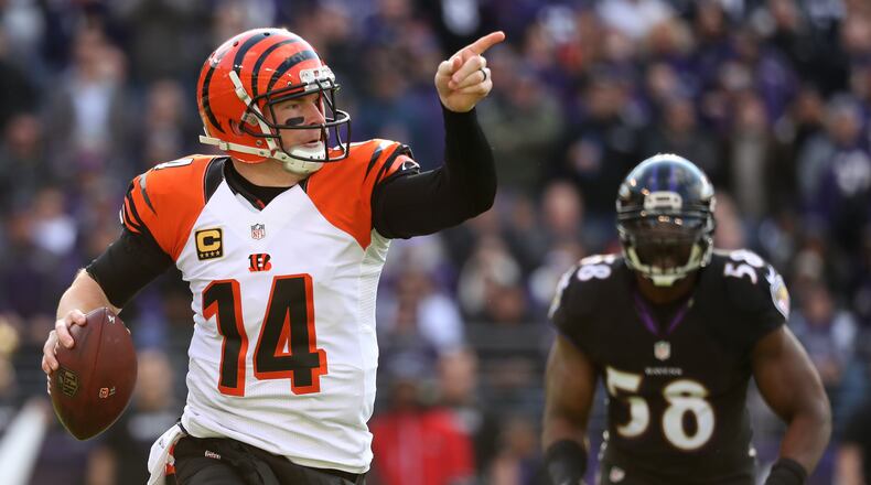 BALTIMORE, MD - NOVEMBER 27: Quarterback Andy Dalton #14 of the Cincinnati Bengals looks to pass while under pressure from outside linebacker Elvis Dumervil #58 of the Baltimore Ravens in the first quarter at M&T Bank Stadium on November 27, 2016 in Baltimore, Maryland. (Photo by Rob Carr/Getty Images)