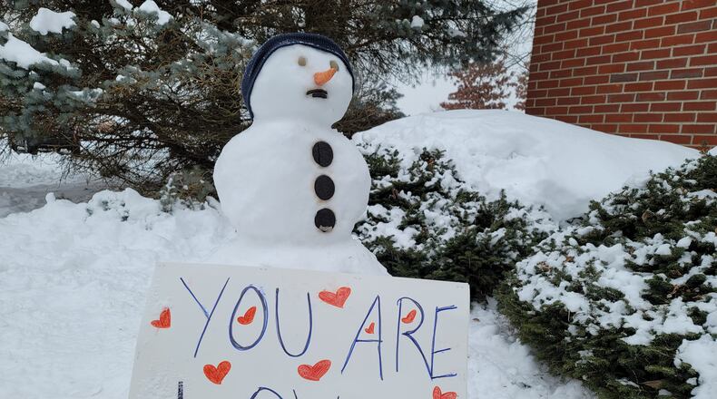 Local children built snowmen Tuesday at The Woodlands of Hamilton assisted living and memory-care live-in community. NICK GRAHAM / STAFF