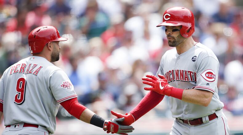 CLEVELAND, OH - JUNE 12: Curt Casali #12 of the Cincinnati Reds celebrates with Jose Peraza #9 after hitting a solo home run off Nick Goody #44 of the Cleveland Indians during the seventh inning at Progressive Field on June 12, 2019 in Cleveland, Ohio. (Photo by Ron Schwane/Getty Images)