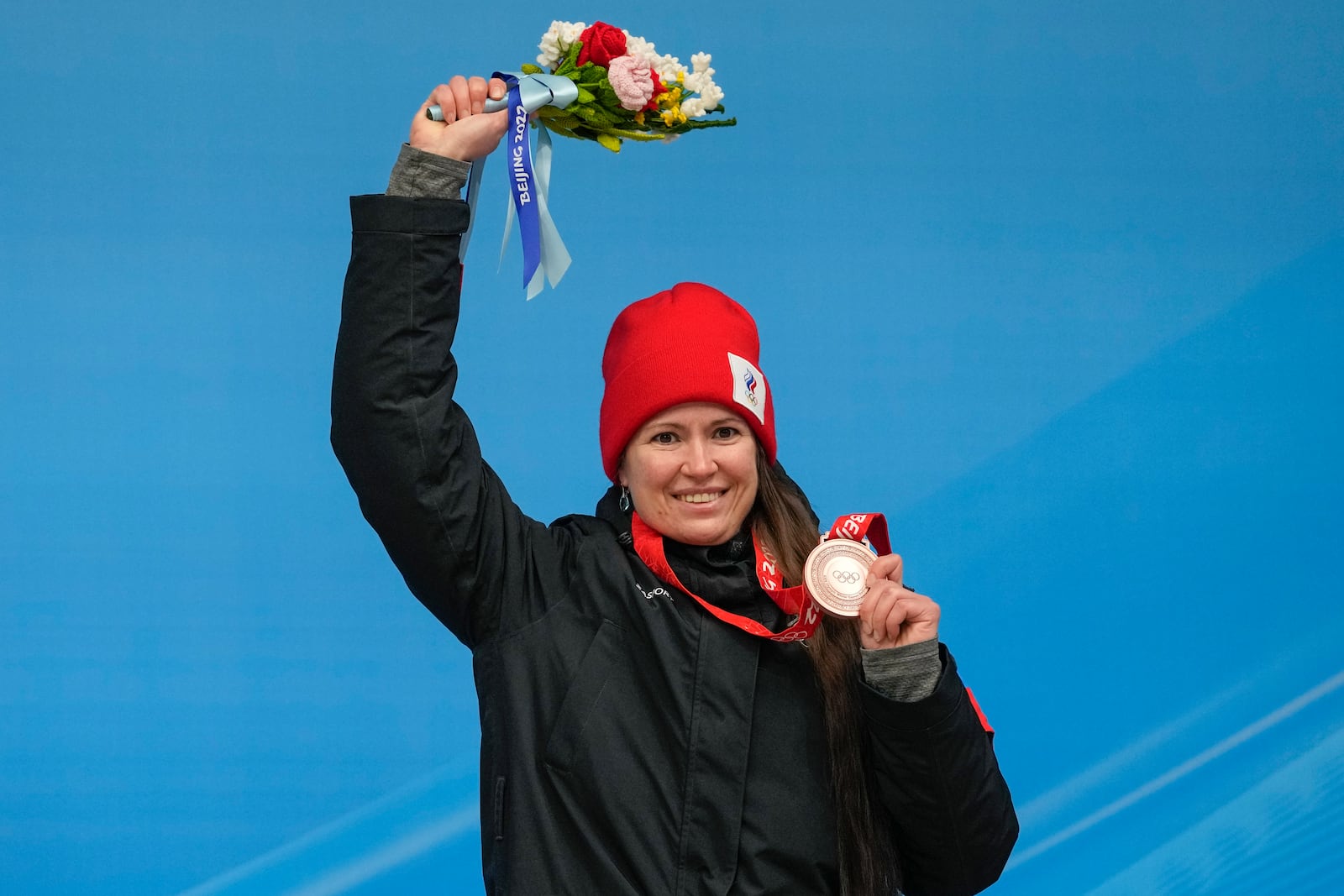 FILE - Tatyana Ivanova, of Russian Olympic Committee, celebrates winning the bronze medal in the luge women's singles at the 2022 Winter Olympics, Tuesday, Feb. 8, 2022, in the Yanqing district of Beijing. (AP Photo/Mark Schiefelbein, File)