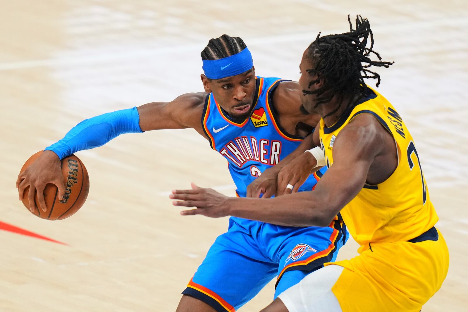 Indiana Pacers forward Aaron Nesmith, right, defends against Oklahoma City Thunder guard Shai Gilgeous-Alexander (2) during the second half of Game 2 of the NBA Finals basketball series Sunday, June 8, 2025, in Oklahoma City. (AP Photo/Kyle Phillips)