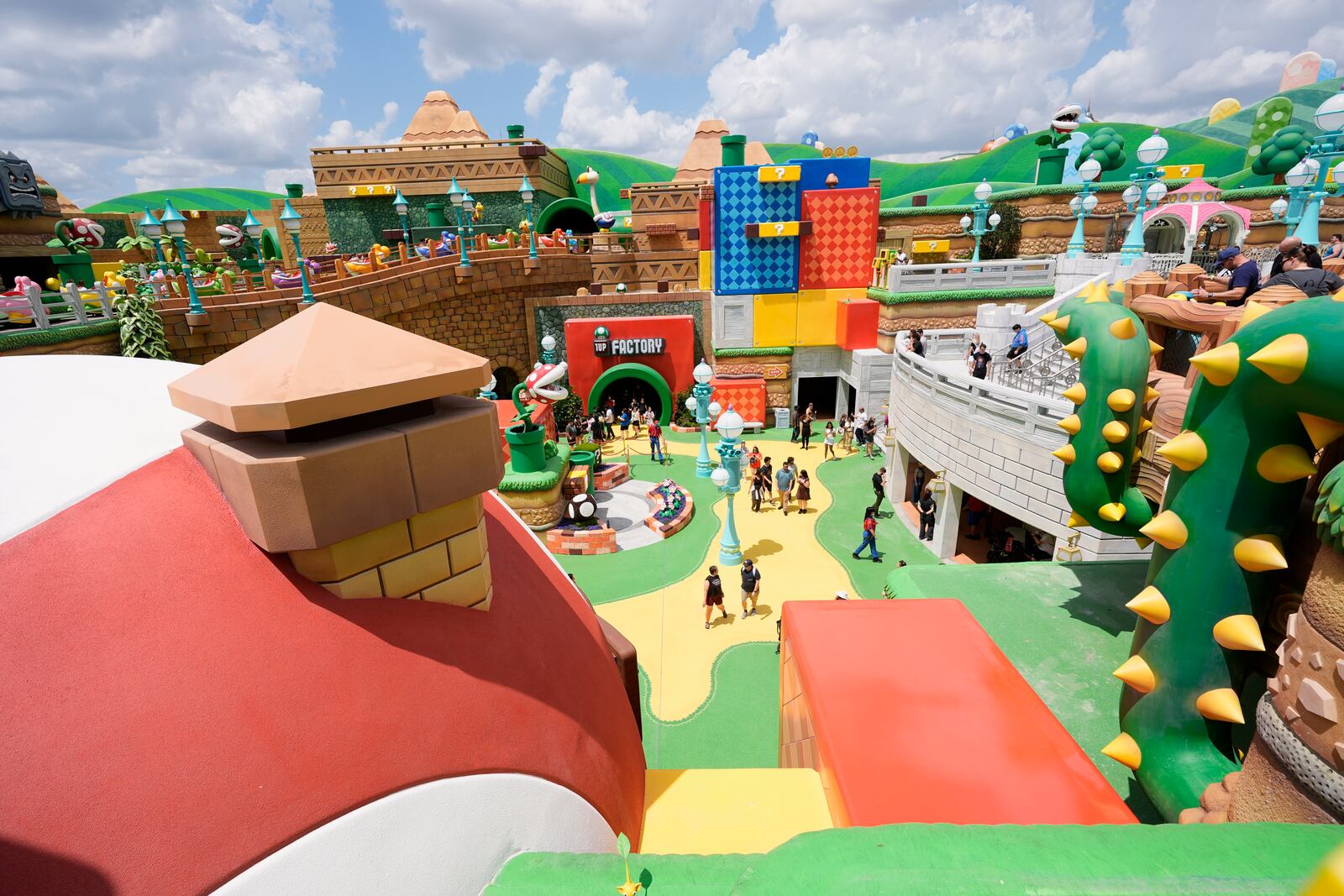 Guests stroll around the various parts of Super Nintendo World at Epic Universe at Universal Resort Orlando Thursday, April 10, 2025, in Orlando, Fla. (AP Photo/John Raoux)