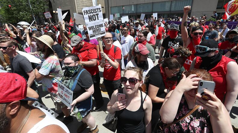Hundreds of protesters rallied together against hate Saturday along Main Street in Downtown Dayton. BILL LACKEY/STAFF