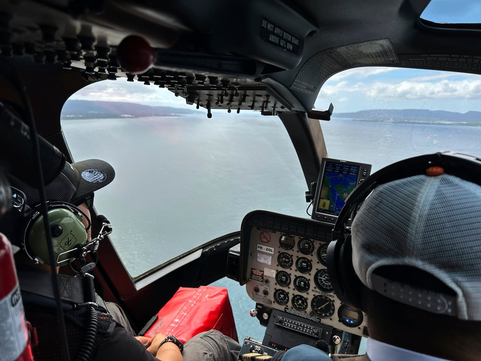 Crew fly a helicopter flying over the Bali Strait during a search operation for the victims of a late Wednesday ferry sinking near the resort island of Bali, Indonesia, Friday, July 4, 2025. (AP Photo/Firdia Lisnawati)