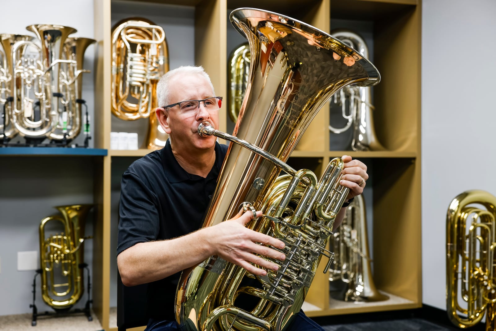 Chris Hite, repair technician and low brass specialist, shows off the tuba and euphonium room at the new Willis Music location at 9482 Meridian Way in West Chester Township. The location features a large variety of brass and wind instruments, percussion, guitars, repair shop, lessons and more. NICK GRAHAM/STAFF