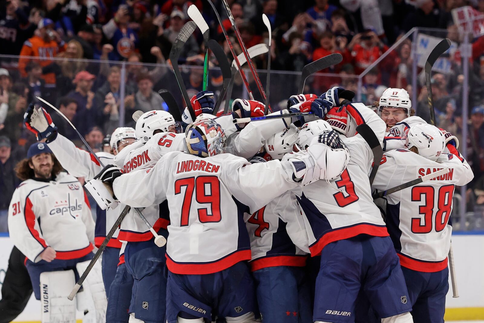 Washington Capitals left wing Alex Ovechkin (8) celebrates with teammates after scoring against New York Islanders during the second period of an NHL hockey game in Elmont, N.Y., Sunday, April 6, 2025. (AP Photo/Adam Hunger)