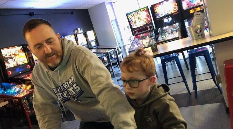 Jim Foliano, left, practices pinball at the Pinball Garage in Hamilton. Foliano is playing pinball on an Avengers: Infinity Quest Pinball Machine – the one he will play to break a world record. CONTRIBUTED