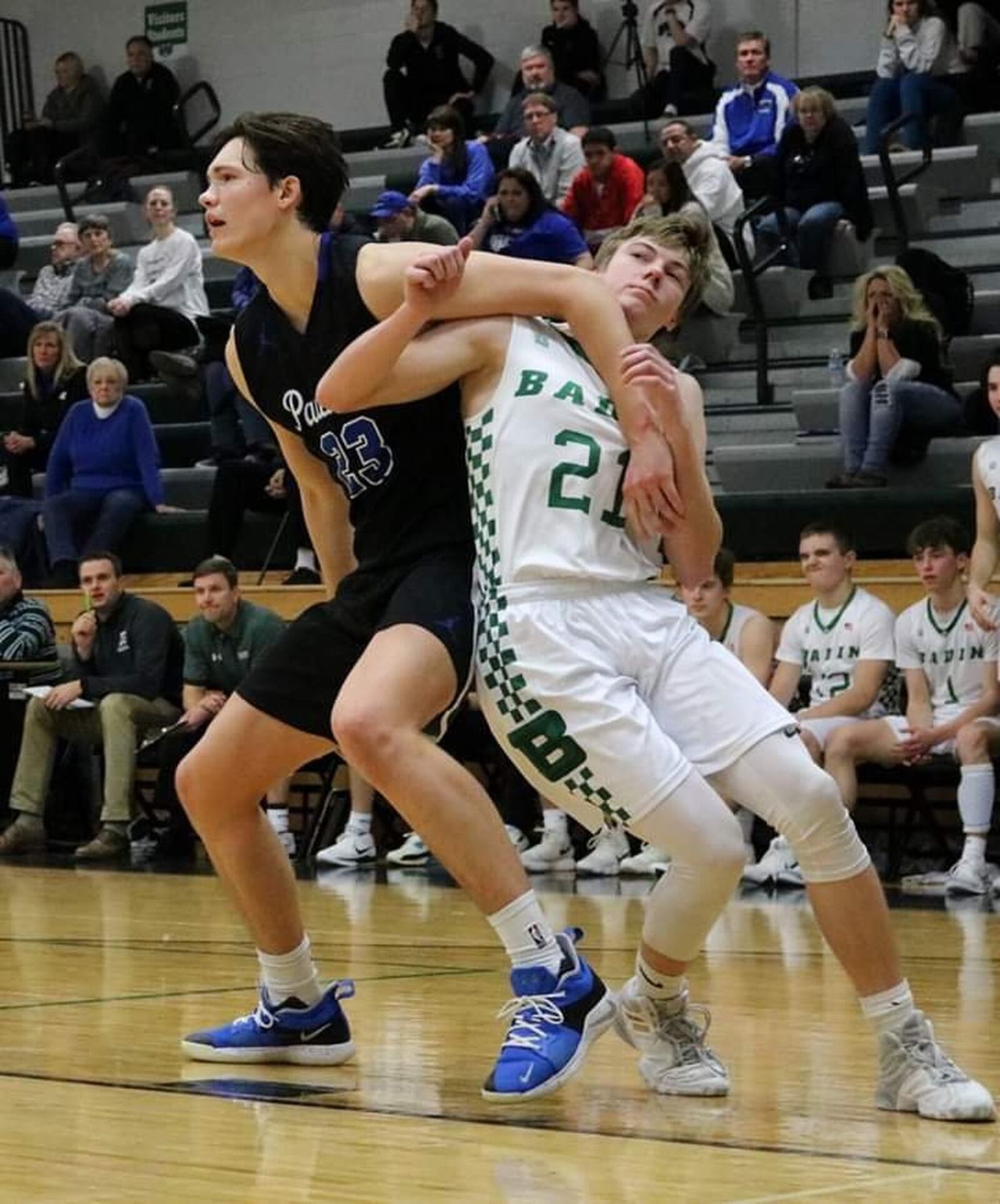 Badin’s Josh Hegemann (21) gets tangled up with Springboro’s Michael Berner (23) during Tuesday night’s game at Mulcahey Gym in Hamilton. Badin won 55-47. CONTRIBUTED PHOTO BY TERRI ADAMS