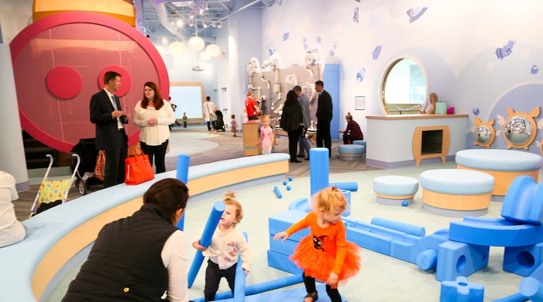 Shoppers visit the children’s area in the Foundry at Liberty Center. GREG LYNCH / STAFF