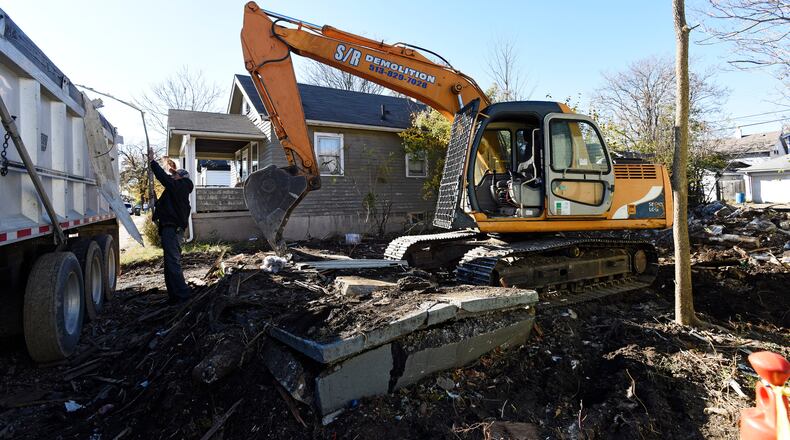 In this 2016 file photo, S/R Demolition demolishes a house in Hamilton. Funds for the demolition were received through the Butler County Land Bank. NICK GRAHAM/STAFF