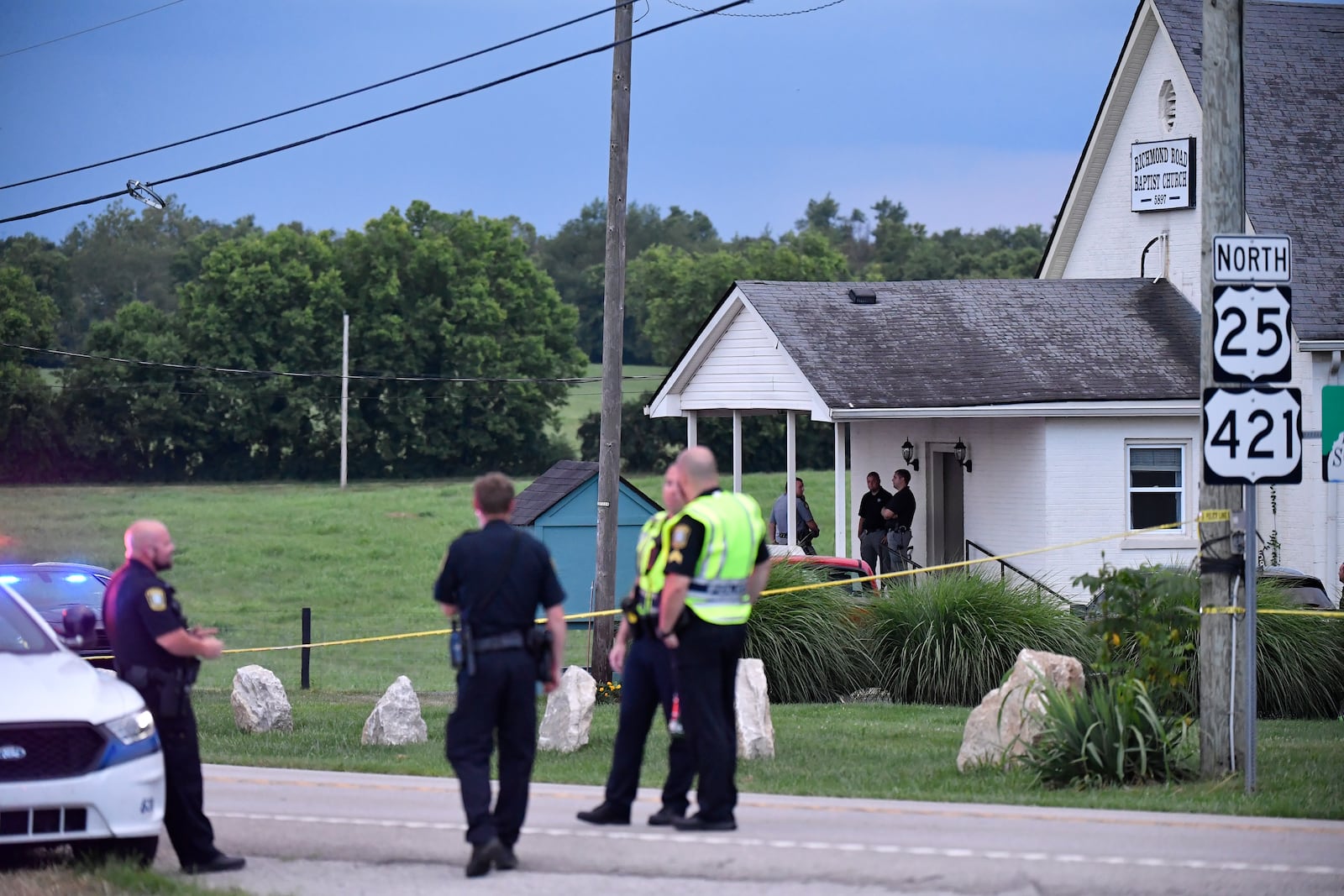 Police stand at the front of the Richmond Road Baptist Church as other officers maintain a perimeter following a shooting at the church in Lexington, Ky., Sunday, July 13, 2025. (AP Photo/Timothy D. Easley)