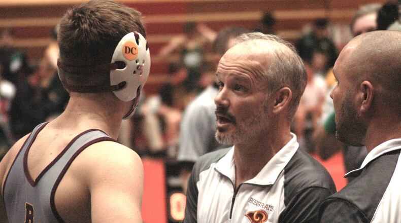 Ross head coach Rich Dunn talks things over with Logan Iams during his match against Akron St. Vincent-St. Mary Sunday at St. John Arena. Ross advance to the semis before falling to Mentor Lake Catholic. John Cummings/CONTRIBUTED
