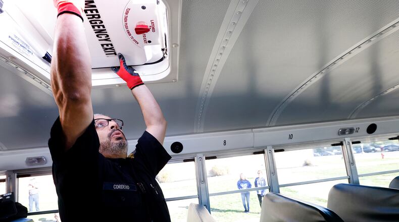 Motor Vehicle Inspector Elvin Cordero demonstrates Monday, Oct. 21, 2024 at Springboro High School all the checks that they perform during a safety inspection on a school bus. Since 2019, there have been 6,145 traffic crashes involving school buses in Ohio. MARSHALL GORBY\STAFF