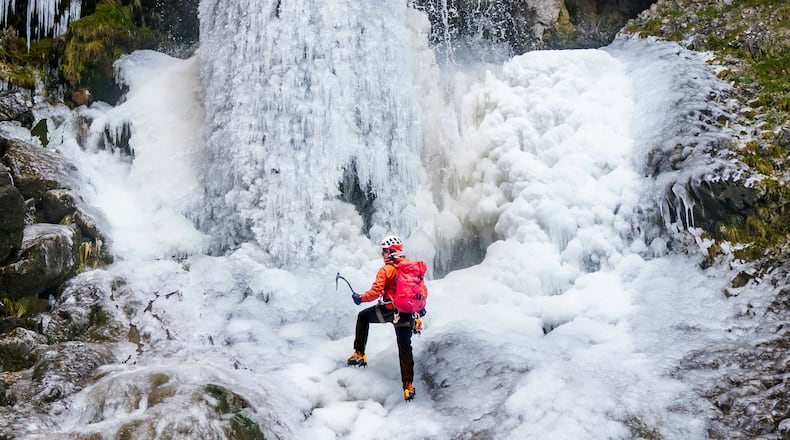 Lost Earth Adventures' instructor Mick Ellerton climbs a frozen waterfall in Gordale Scar near Malham Cove in the Yorkshire Dales National Park, as ice warnings are in place across the UK ahead of a storm which is set to bring heavy snow later in the week, on Wednesday Jan. 7, 2026. (Danny Lawson/PA via AP)